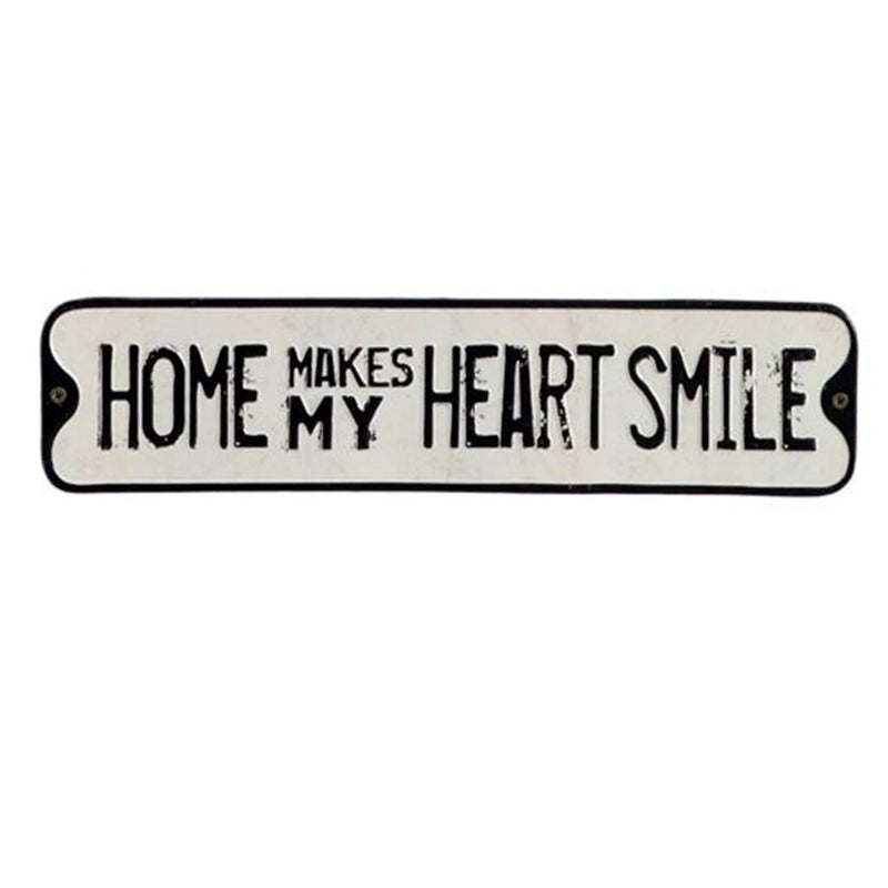 Vintage metal sign with HOME MAKES MY HEART SMILE in black on white, smile embossed tin