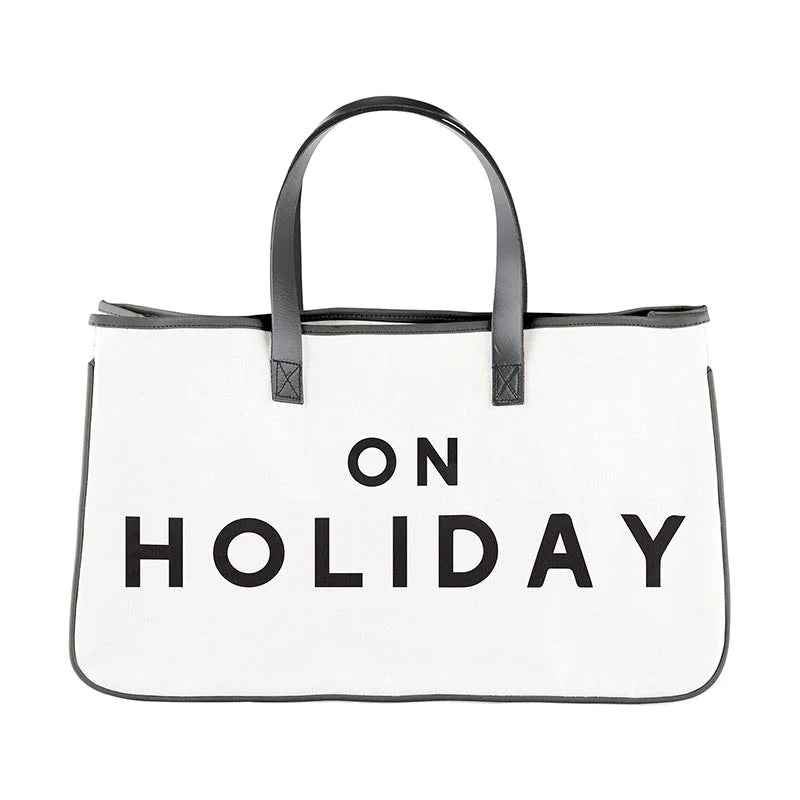 White holiday canvas tote bag featuring bold black lettering for stylish convenience