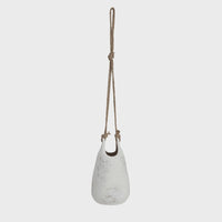 White hanging coarse stoneware planter with jute rope hanger for stylish indoor decor