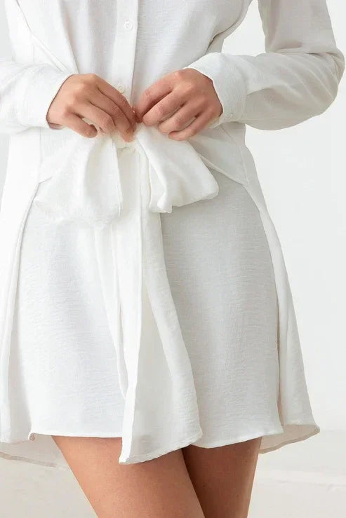 White bathrobe tied at the waist, complementing a Long Sleeve Front Tie Shirt Mini Dress