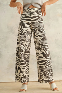 White and black zebra print stretch pants with wide-leg design for stylish comfort