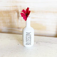 White ceramic bud vase with BLOSSOM text and red flower, ideal for women’s boho chic clothing