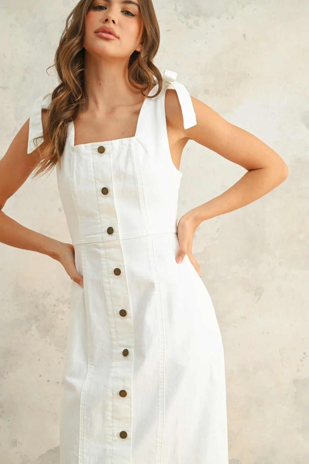 White sleeveless button-down stretch midi dress made from a cotton-spandex blend