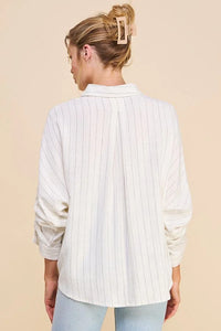 White pinstripe dolman button front shirt worn by person facing away from camera