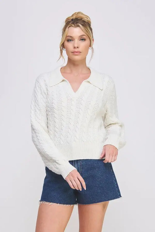 White cable knit johnny collar pullover sweater styled with denim shorts for a chic look