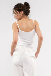 White spaghetti strap tank top with a fitted silhouette from Shop Daisy, perfect for women’s boho chic clothing