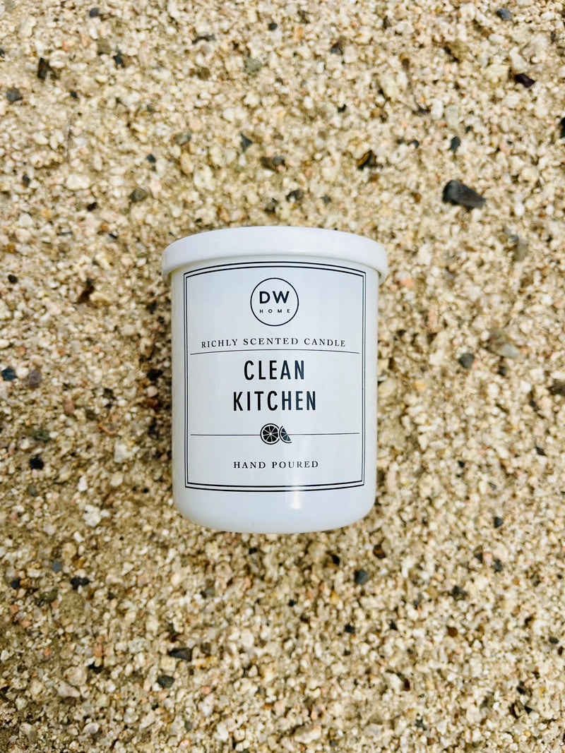 White candle on sandy beach featuring Clean Kitchen Mini with lime zest aroma