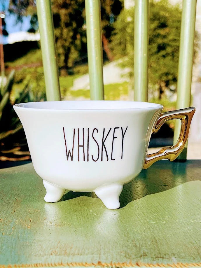 White stoneware footed teacup with WHISKEY design and small feet for added charm