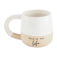 White ceramic LOVE THIS PLACE STONEWARE TEA MUG with beige bottom and ’this is the life’ text