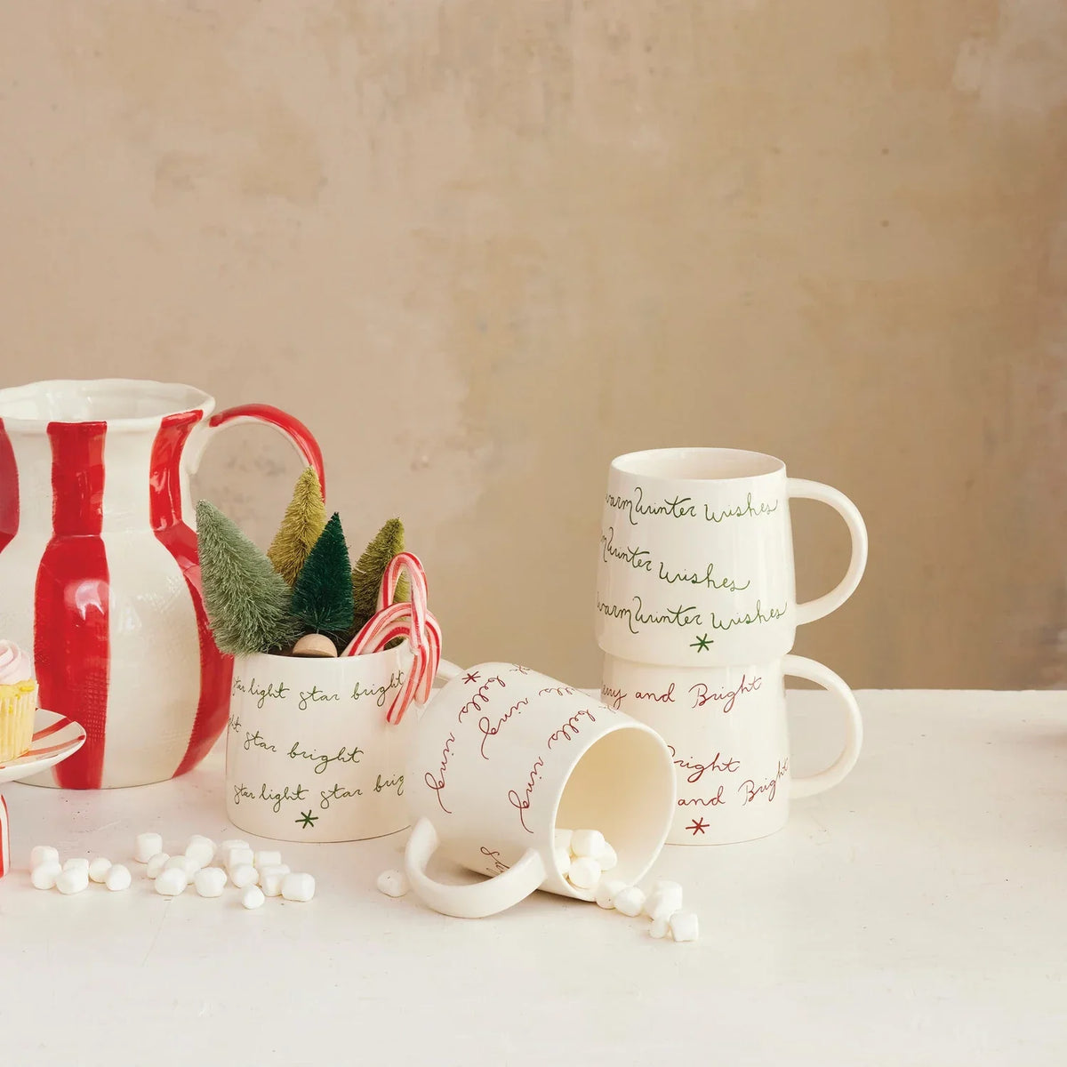 Cream color ceramic mugs with handles and printed script for women’s boho chic clothing at Shop Daisy