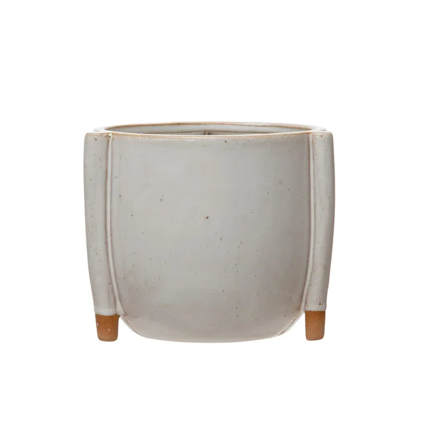 White ceramic stoneware footed planter with wooden feet, showcasing a reactive glaze design