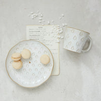 White ceramic plate with Christmas tree design and macarons, perfect for debossed stoneware Christmas mugs