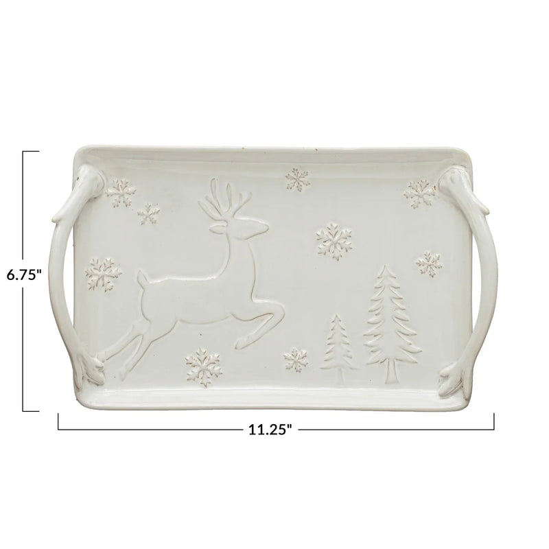 White ceramic serving tray with winter-themed reindeer, snowflakes, and trees design