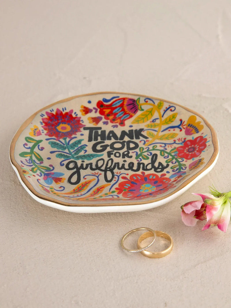 White ceramic artsy trinket dish with colorful floral patterns and gold trim