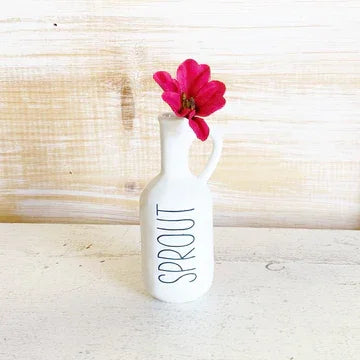 White ceramic vase with SPROUT text and pink flower, perfect for women’s boho chic clothing