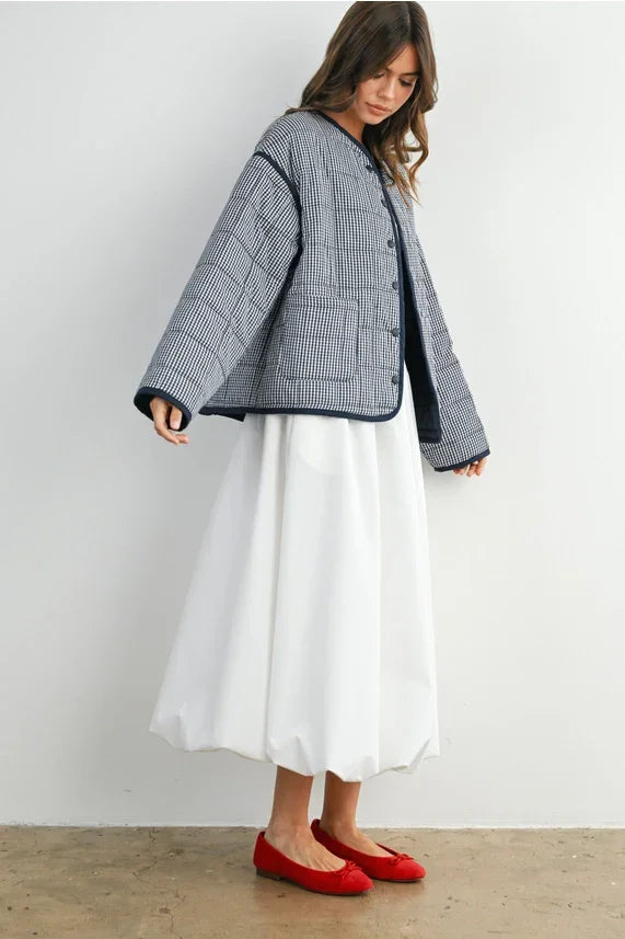 Buttoned quilted puffer jacket with white cotton midi skirt and red ballet flats