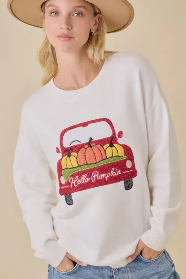 White crew neck long-sleeve sweatshirt with pumpkin truck embroidered patchwork graphic