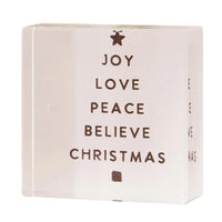 White decorative Christmas themed lucite block arranged in a tree shape