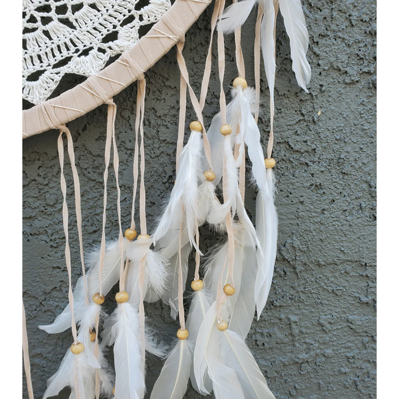 White dream catcher on a wall, perfect for boho decor and blocking bad dreams