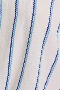 White fabric with blue striped pattern on a V-Neck Folded Short Sleeve Stripe Blouse