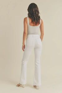 White mid rise flare pants paired with a fitted tank top viewed from behind