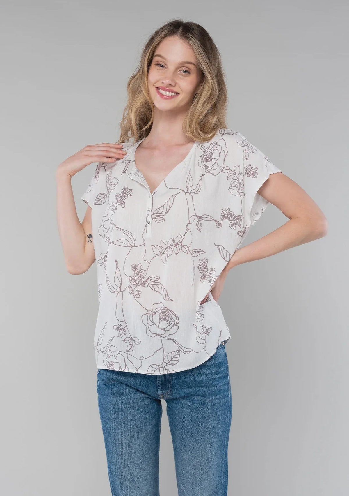 White floral print short dolman sleeve button-up blouse paired with blue jeans
