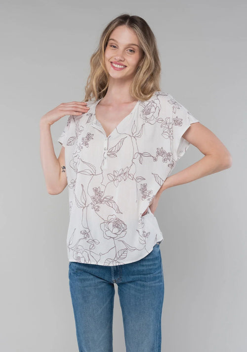 White floral print short dolman sleeve button-up blouse paired with blue jeans