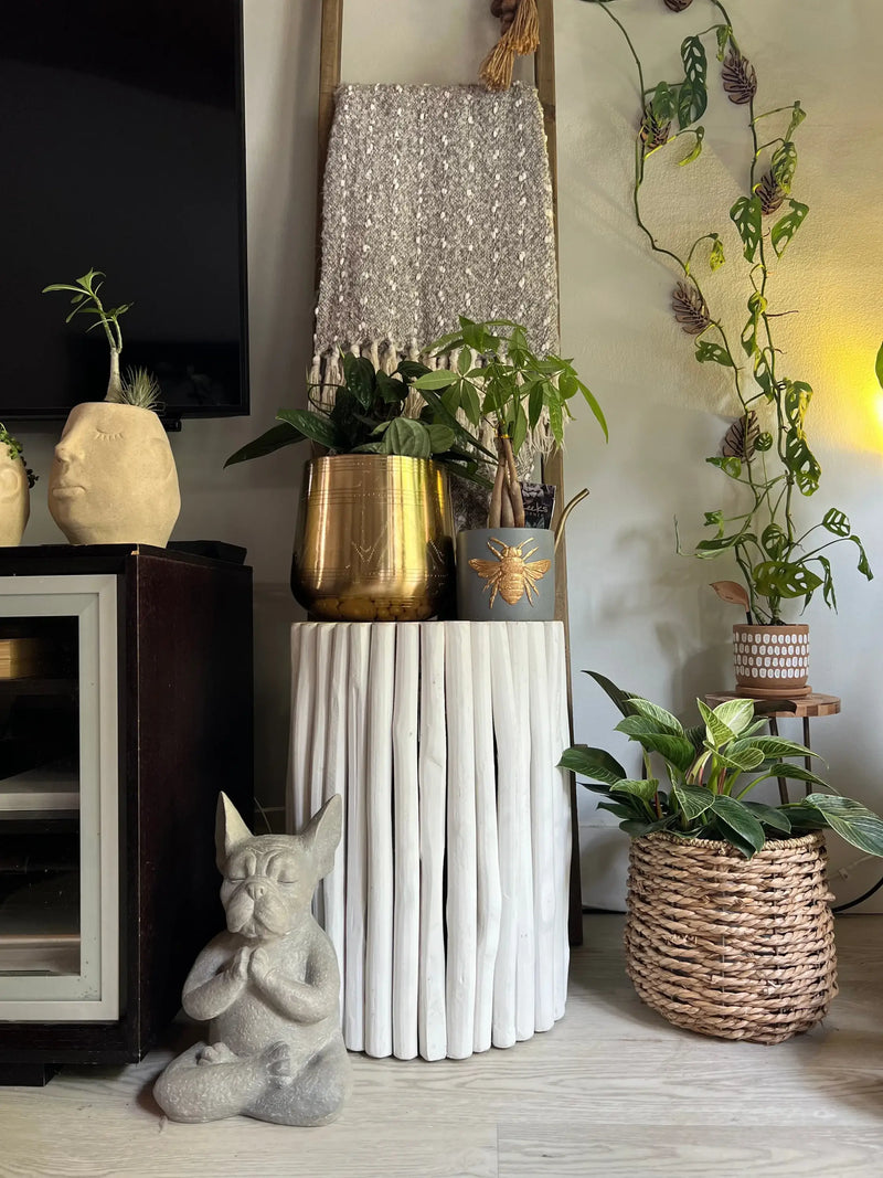 White fluted pedestal column supporting a gold metal planter for TULUM FLORAL POT PLANTER