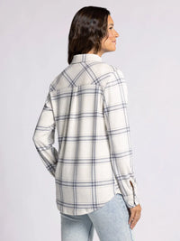 Woman in a white and gray plaid collared button-up, showcasing the Plush Collared Button Down Top