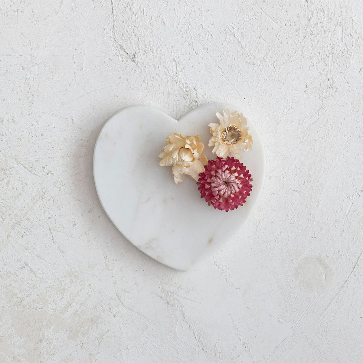 White flowers elegantly arranged on a Marble Heart Shaped Dish with a heart shaped design