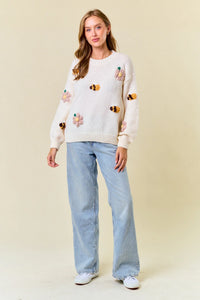 White knit sweater in size small featuring embroidered bumblebees and floral designs