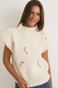 White knit mock neck power shoulder sweater vest with red candy cane designs