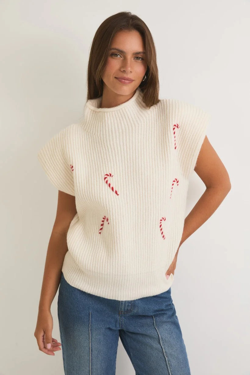 White knit mock neck power shoulder sweater top with red candy cane designs