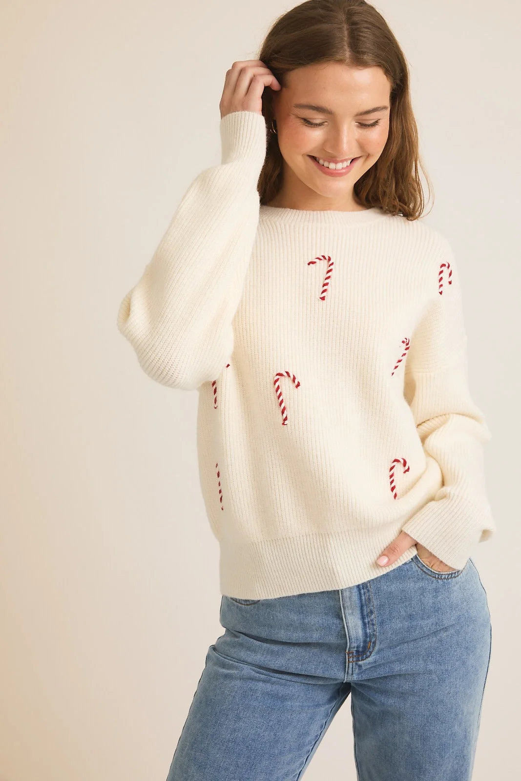 White knit Candy Cane Pullover Sweater featuring a round neck and long sleeves