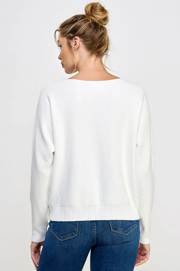 White knit Soft Daisy Embroidered fine gauge sweater with blonde bun from the back