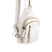 White leather SKYLER SLING BAG with multiple zippered compartments and shoulder strap