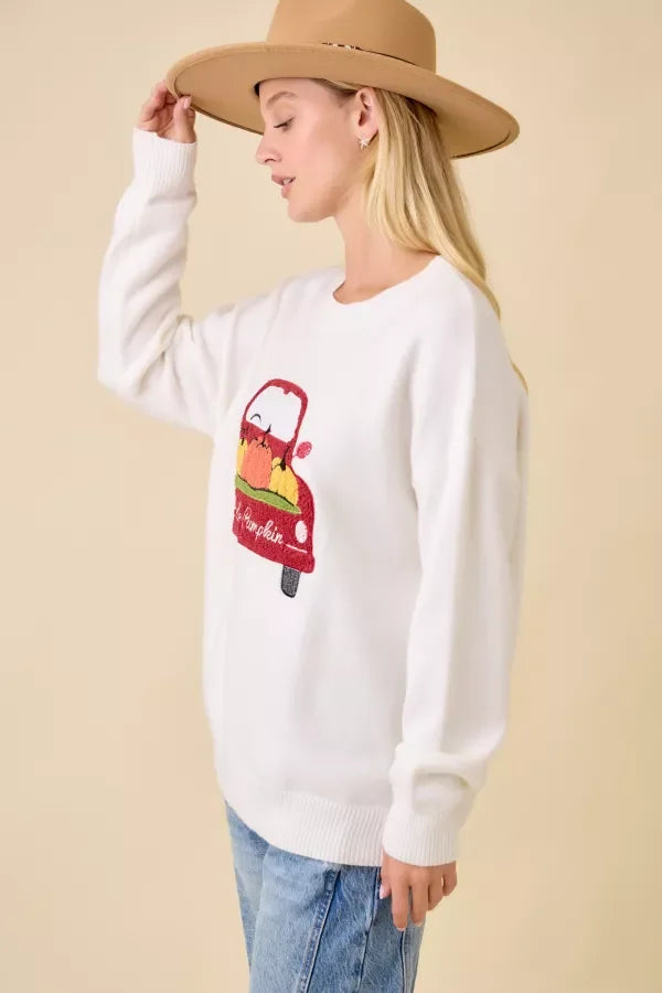 White long-sleeve crewneck sweater with pumpkin truck embroidered patchwork design