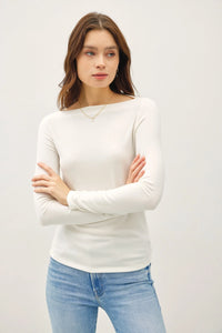 White long sleeve basic boat neck sweater styled with blue jeans for a casual look