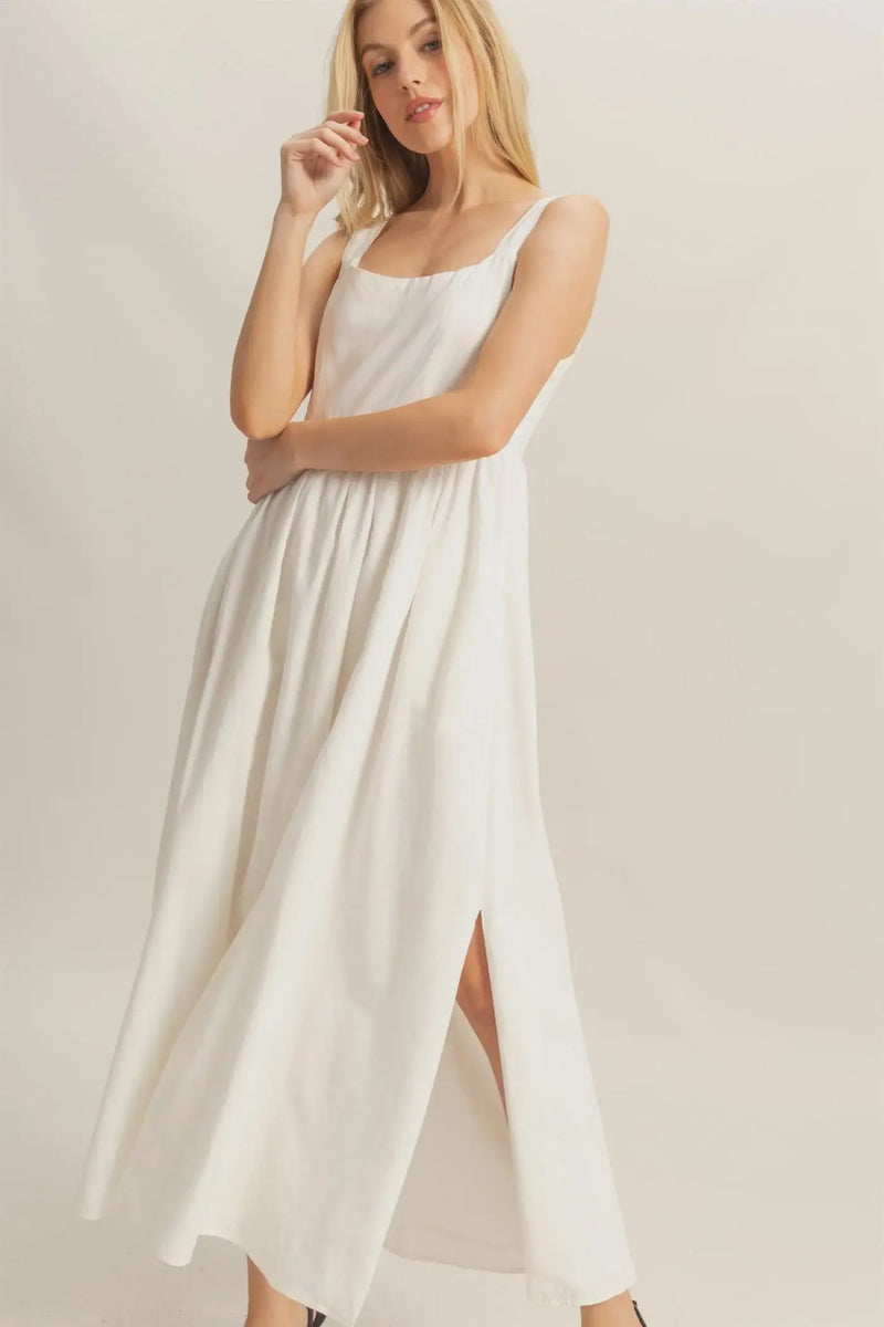 White maxi dress with side slit from Shop Daisy, perfect for women’s boho chic clothing