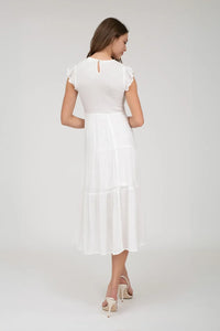 White smocked tiered midi dress showcasing elegant design and fashionable style