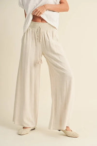 Loose-fitting white Palazzo pants with smocked waist in cotton linen fabric