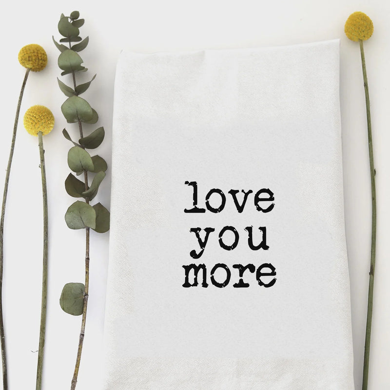 White humorous kitchen hand tea towel featuring love you more text with eucalyptus and craspedia flowers