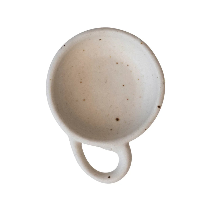 White porcelain cup with handle from the Stoneware Dish collection, featuring boho style