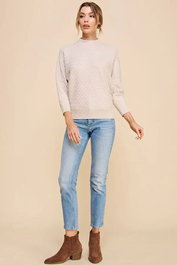 White quilted mock neck dolman sweater with light-wash jeans and brown ankle boots