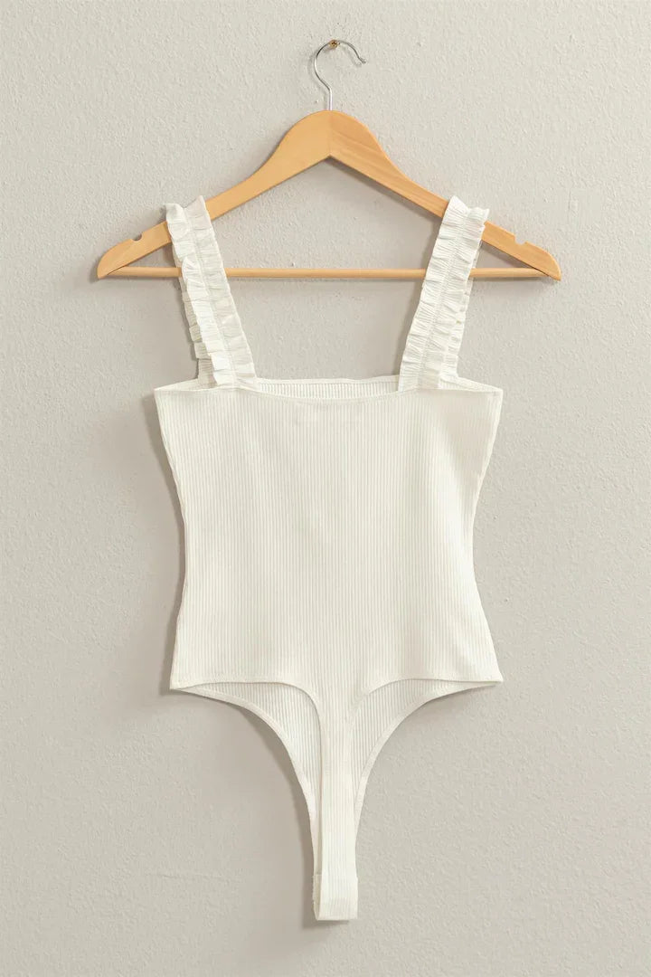 White ribbed ruffle strap bodysuit featuring stylish ruched detailing