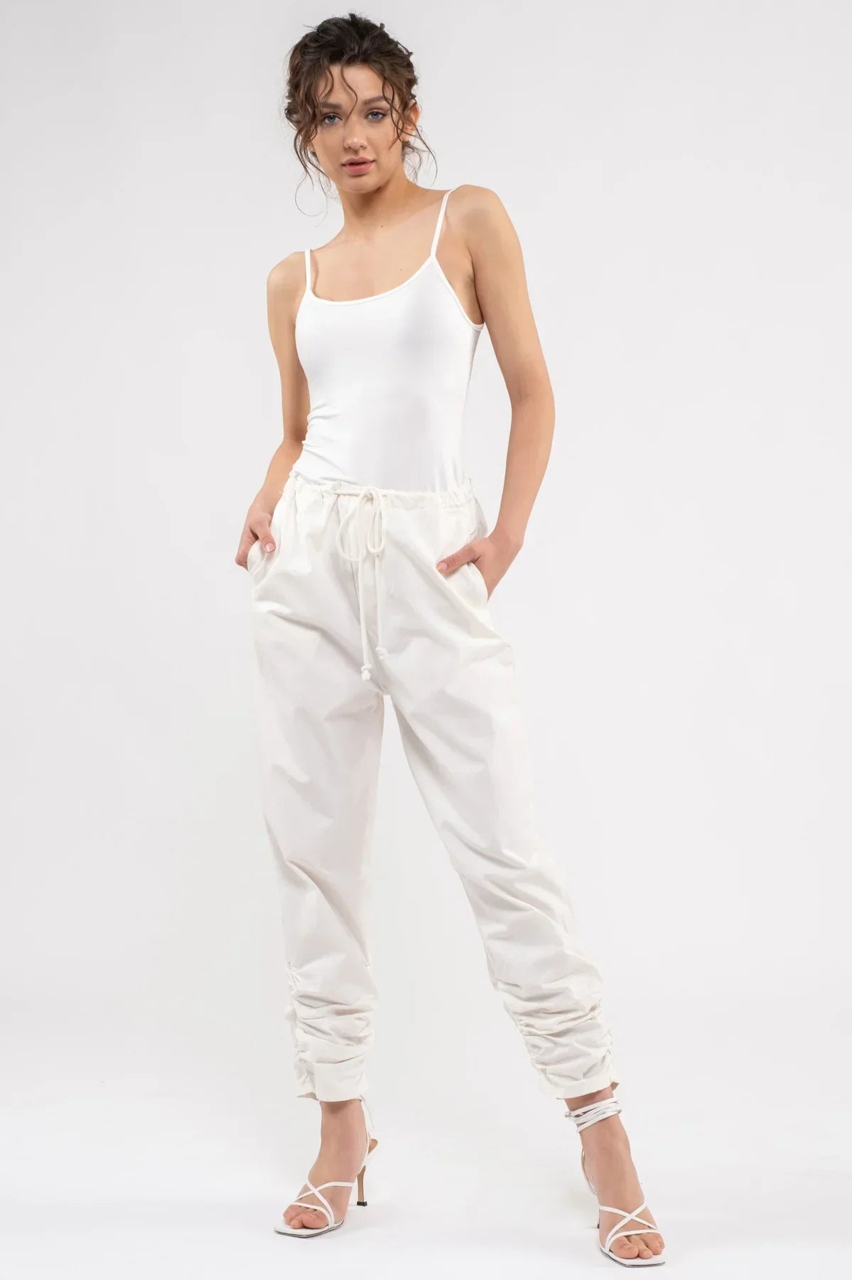 White ruched jogger pants with drawstring waist, paired with Spaghetti Strap Tank Top