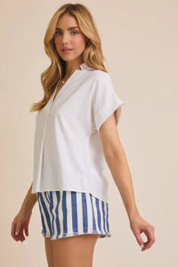 White short-sleeve flare blouse with V-neck and flare hem paired with striped shorts