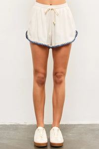 White shorts with blue trim featuring a Rope Elastic Waist Edge for comfortable fit