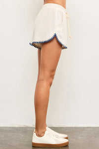 White shorts with blue trim featuring a rope elastic waist for comfortable fit