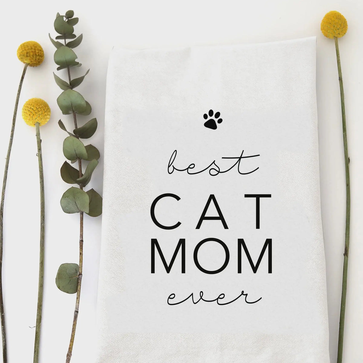 White humor tea towel featuring best cat mom text and paw print design